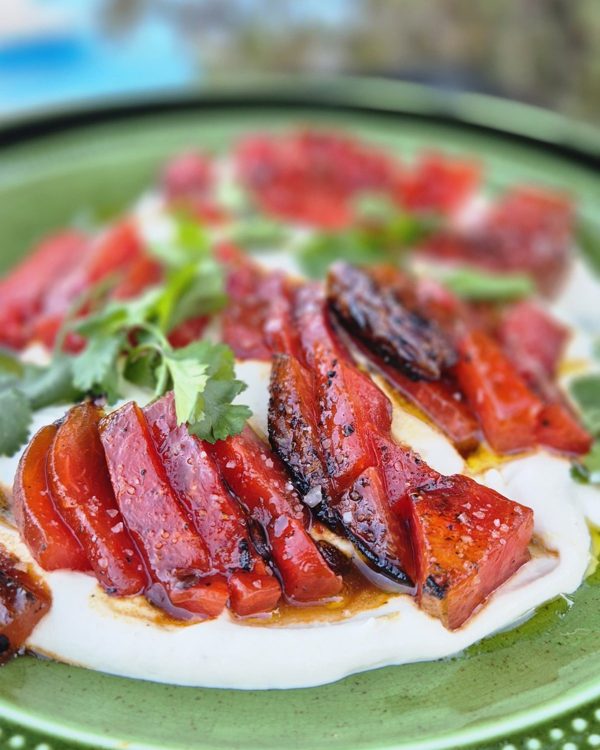 Flame-glazed watermelon steak on white bean cream