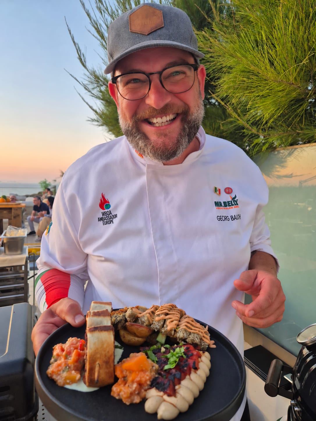 Live-fire vegetarian plate served on a seaside hotel terrace